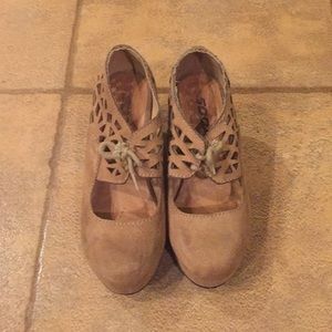 One pair of bright brown high heels.